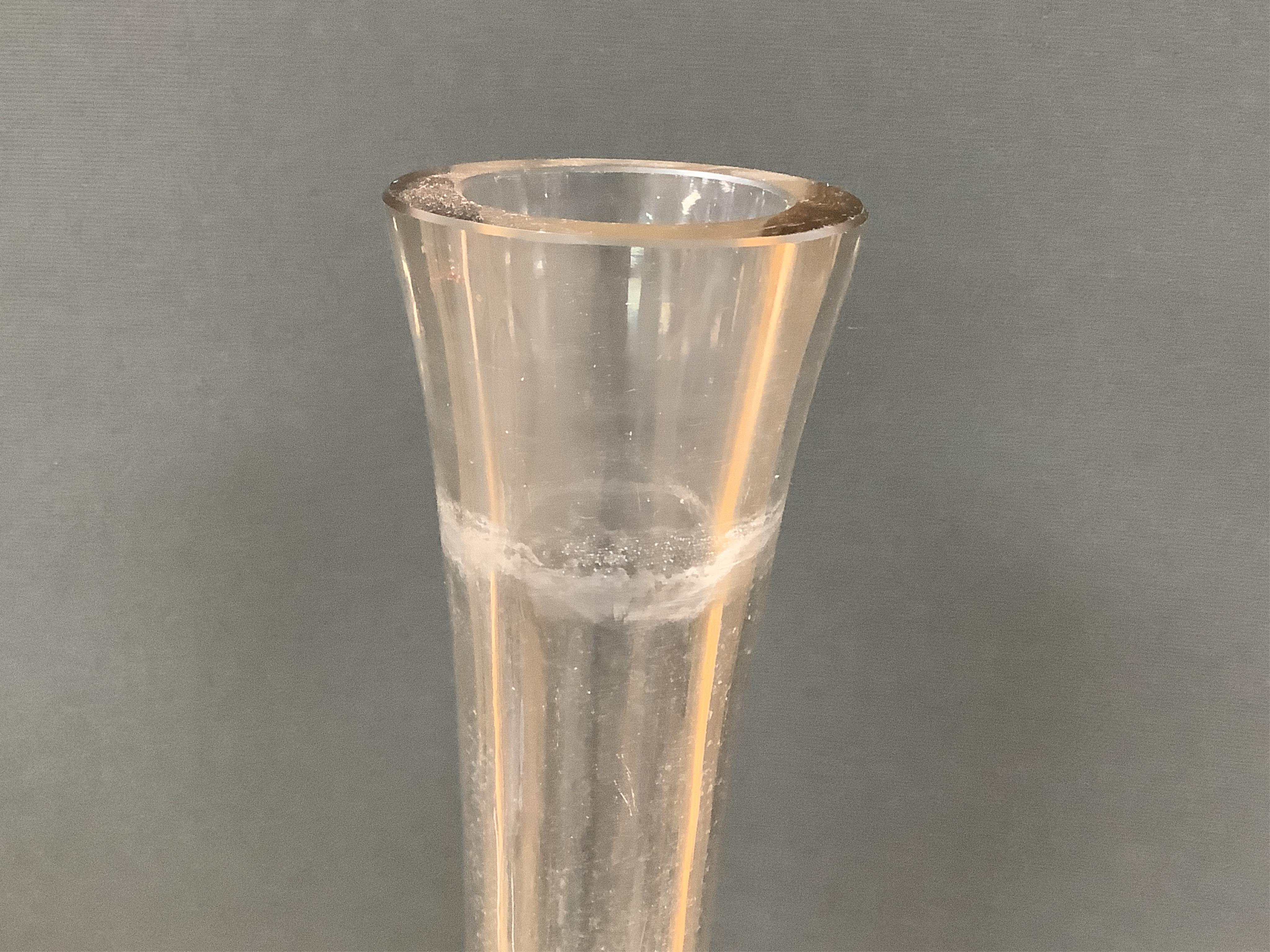A pair of large clear glass chemist window display bottles and stoppers, one with chip, 90cm high
